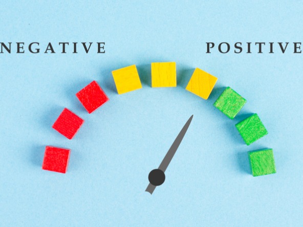 arrow pointing to 'positive' on a scale from red negative to yellow neutral to green positive
